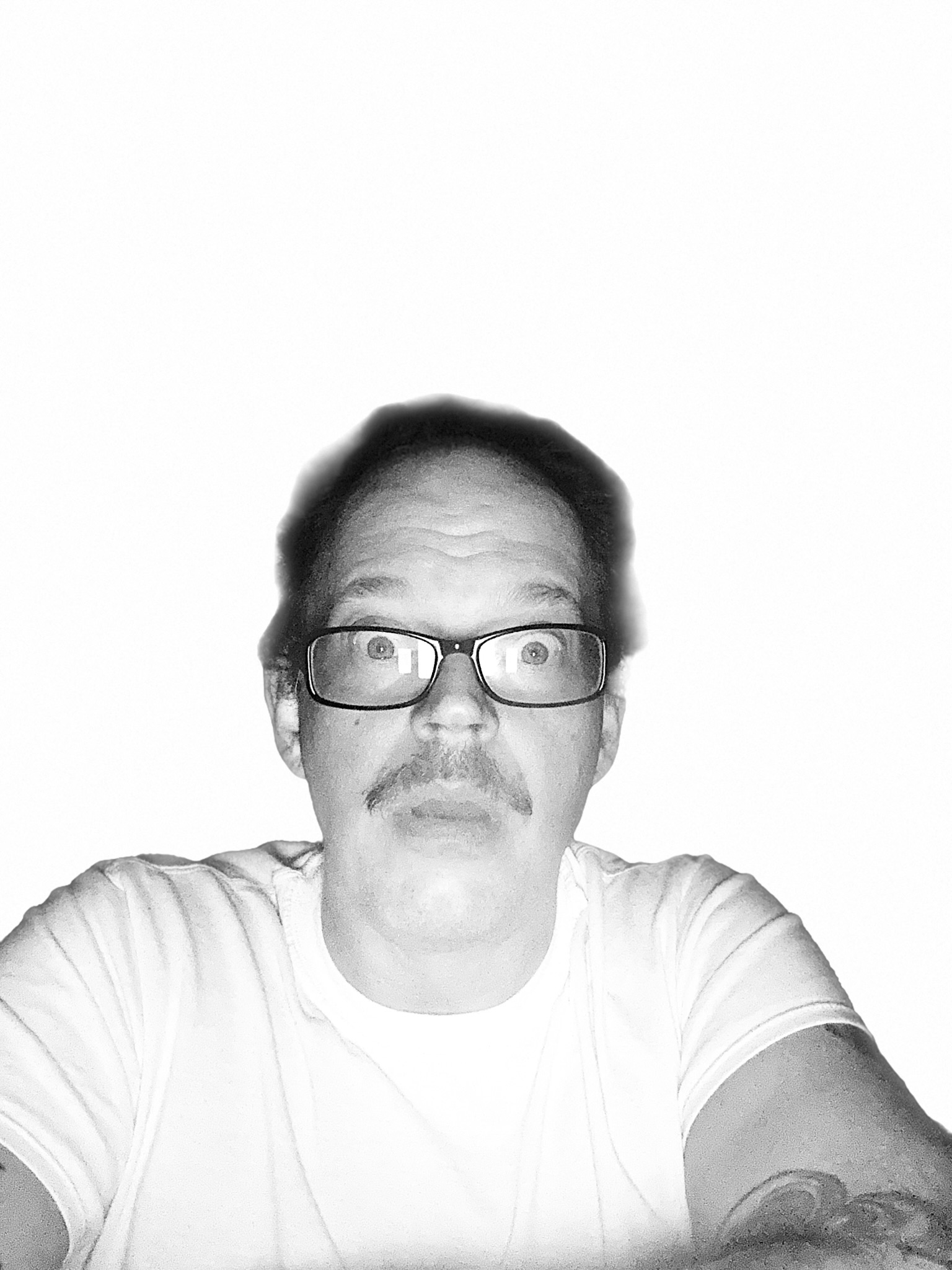 Black-and-white portrait of a man wearing glasses and a white shirt